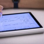Person writing on tablet